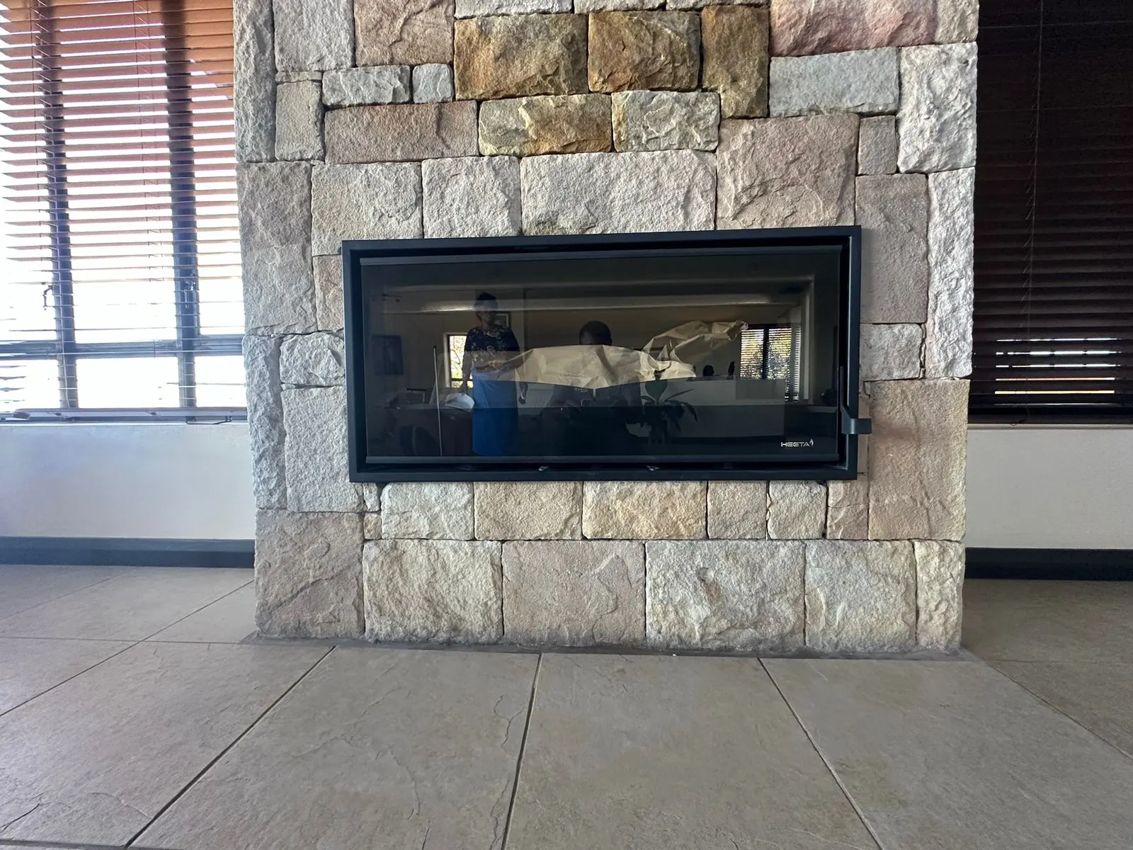 Wide built-in fireplace set into a stone wall