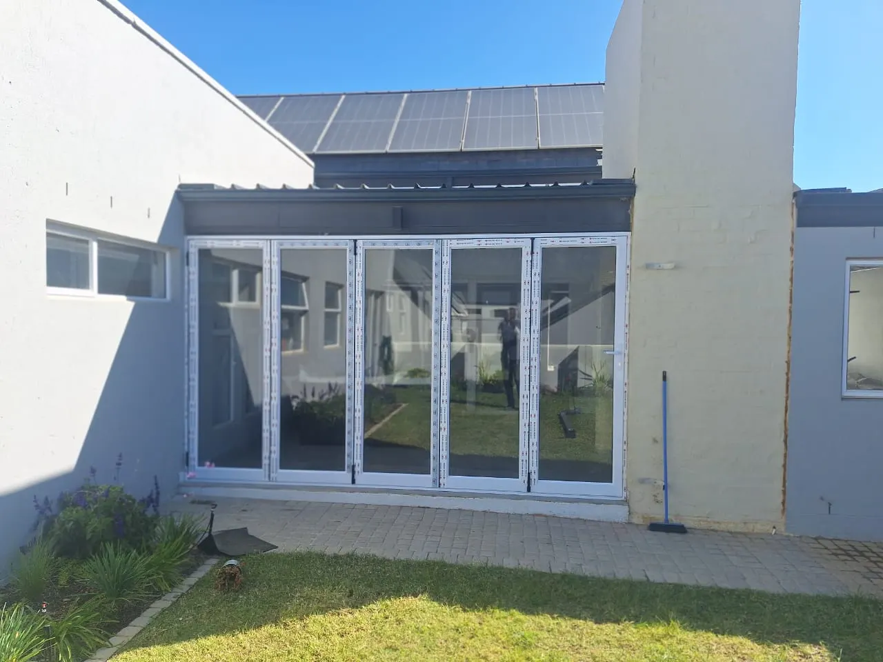 Covered patio closed in with white folding glass doors
