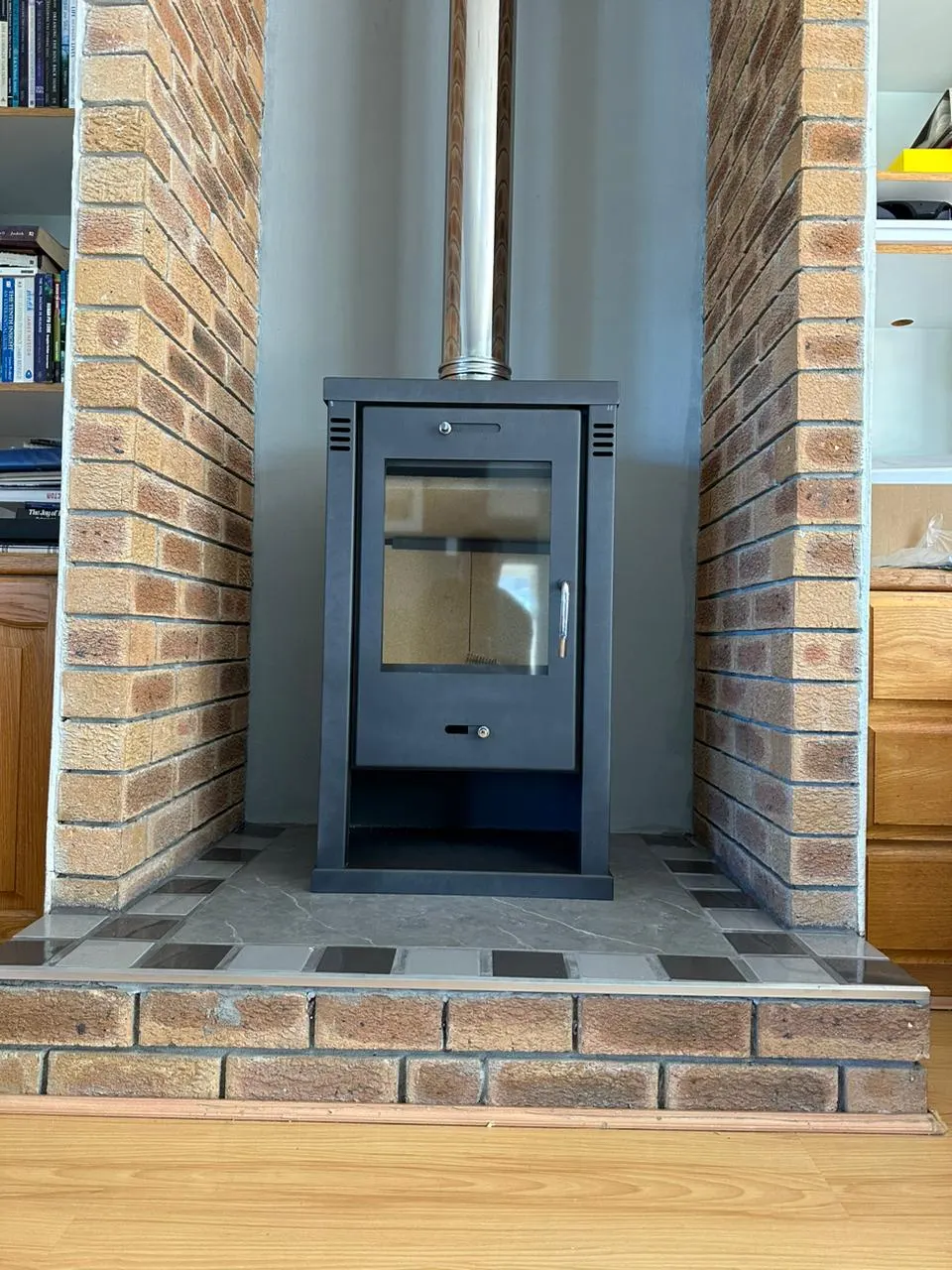 Finished fireplace in a brick alcove