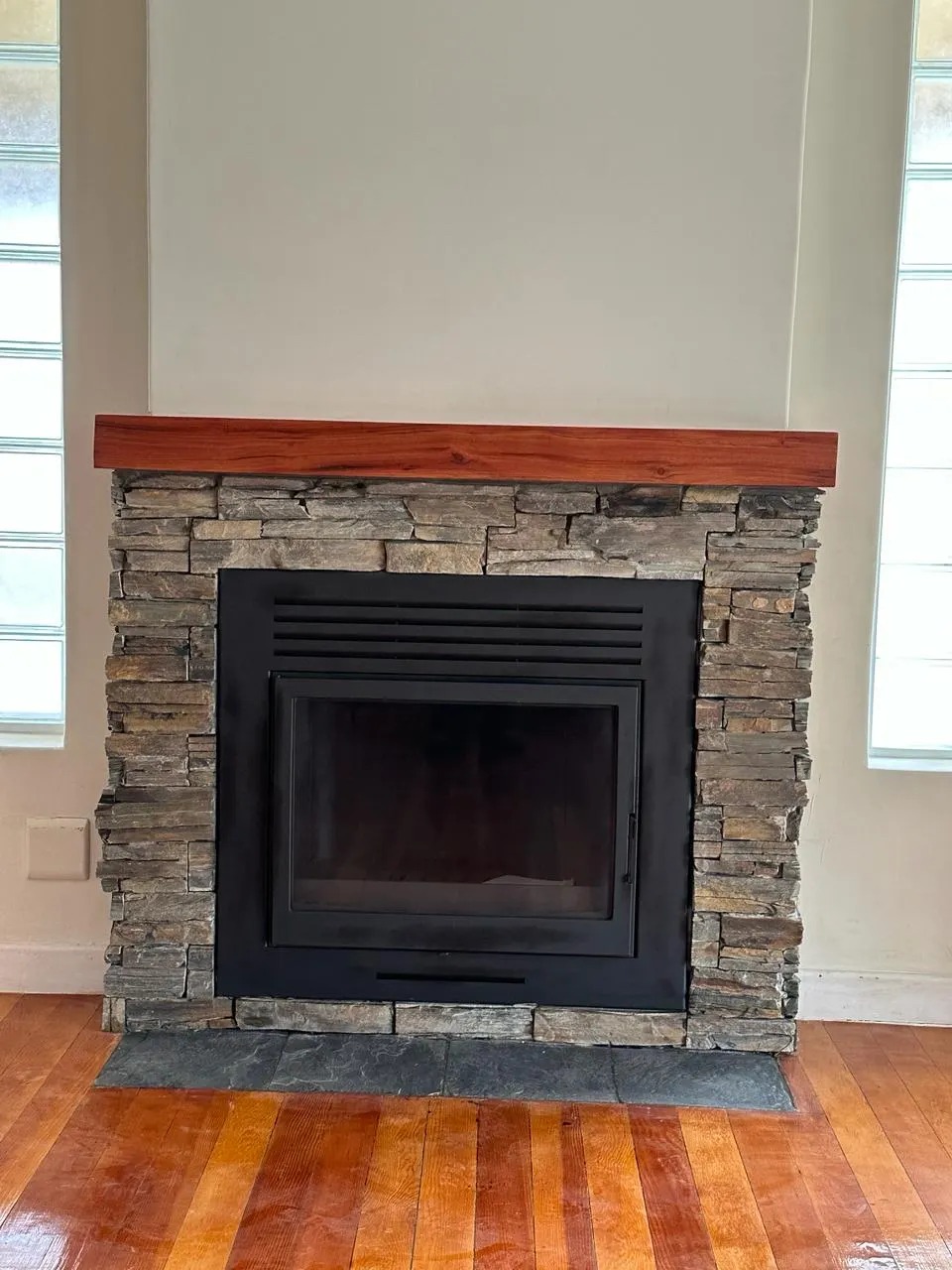 Fireplace with a new stacked stone surround