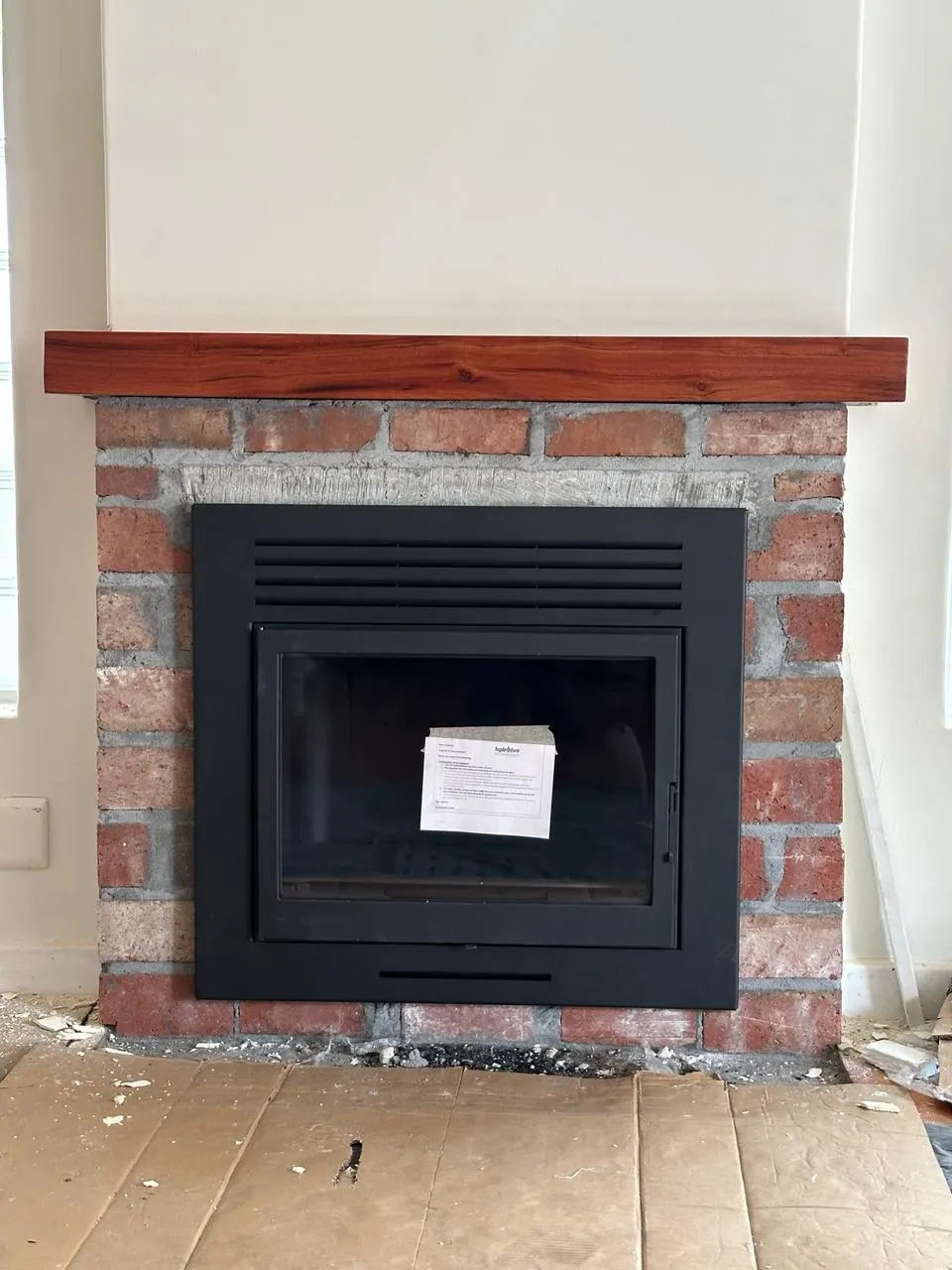 New insert fitted into a repaired brick fireplace