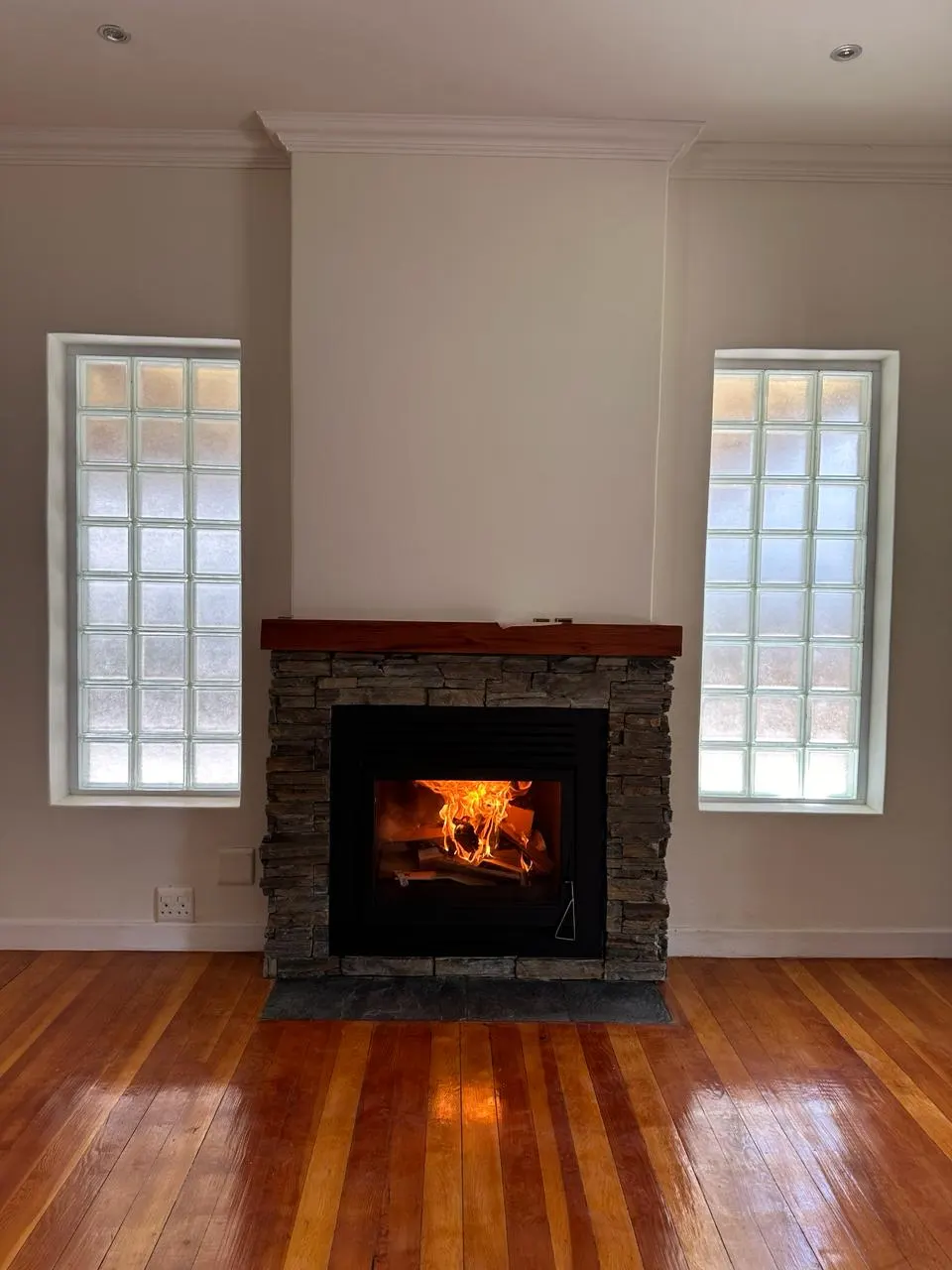 Repaired fireplace with a new stone surround and mantel