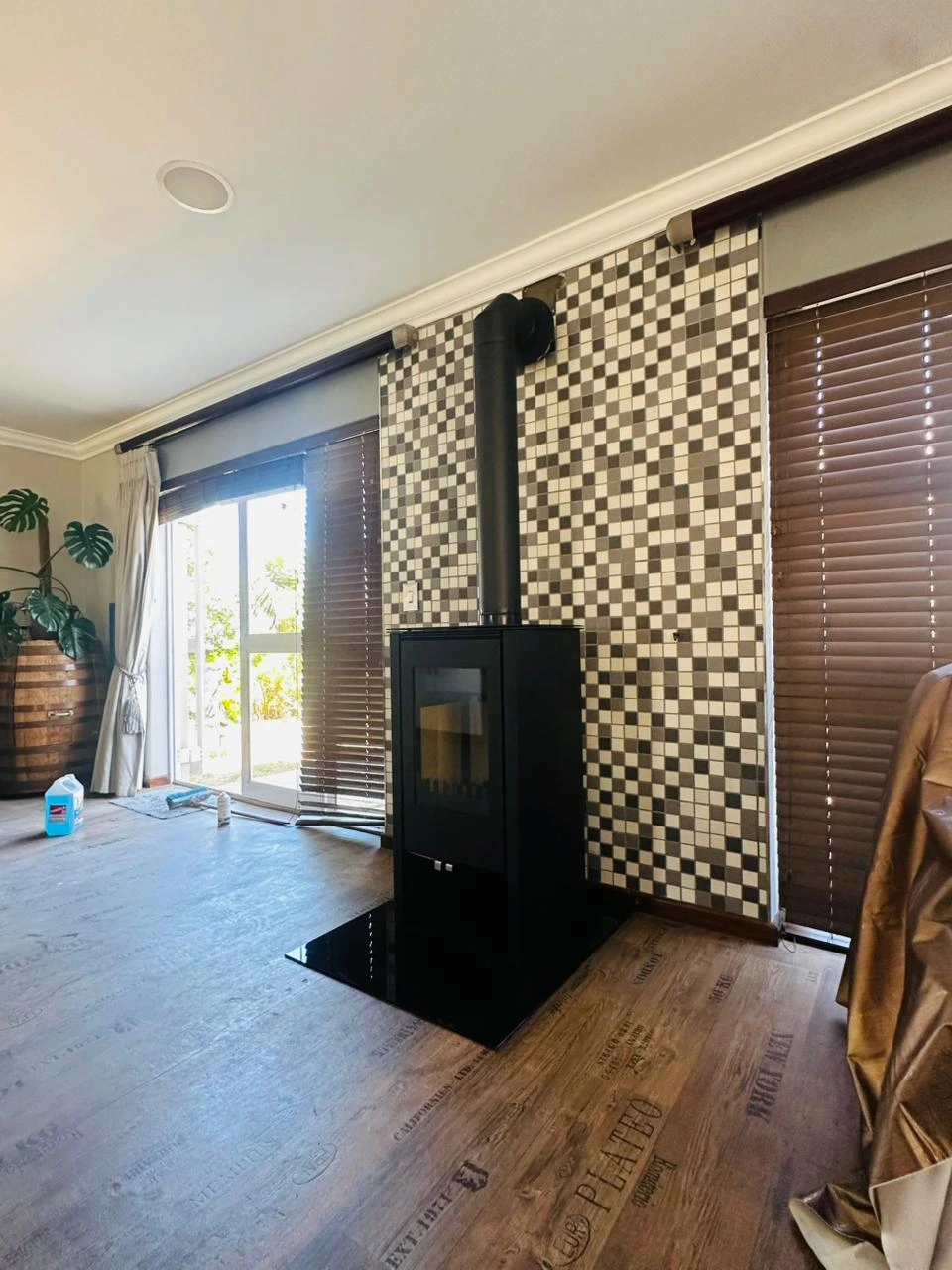 Freestanding fireplace against a mosaic feature wall in Durbanville