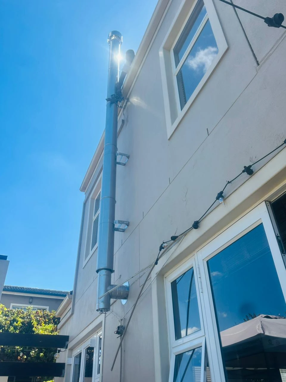 Exterior flue secured to a two-storey Durbanville home