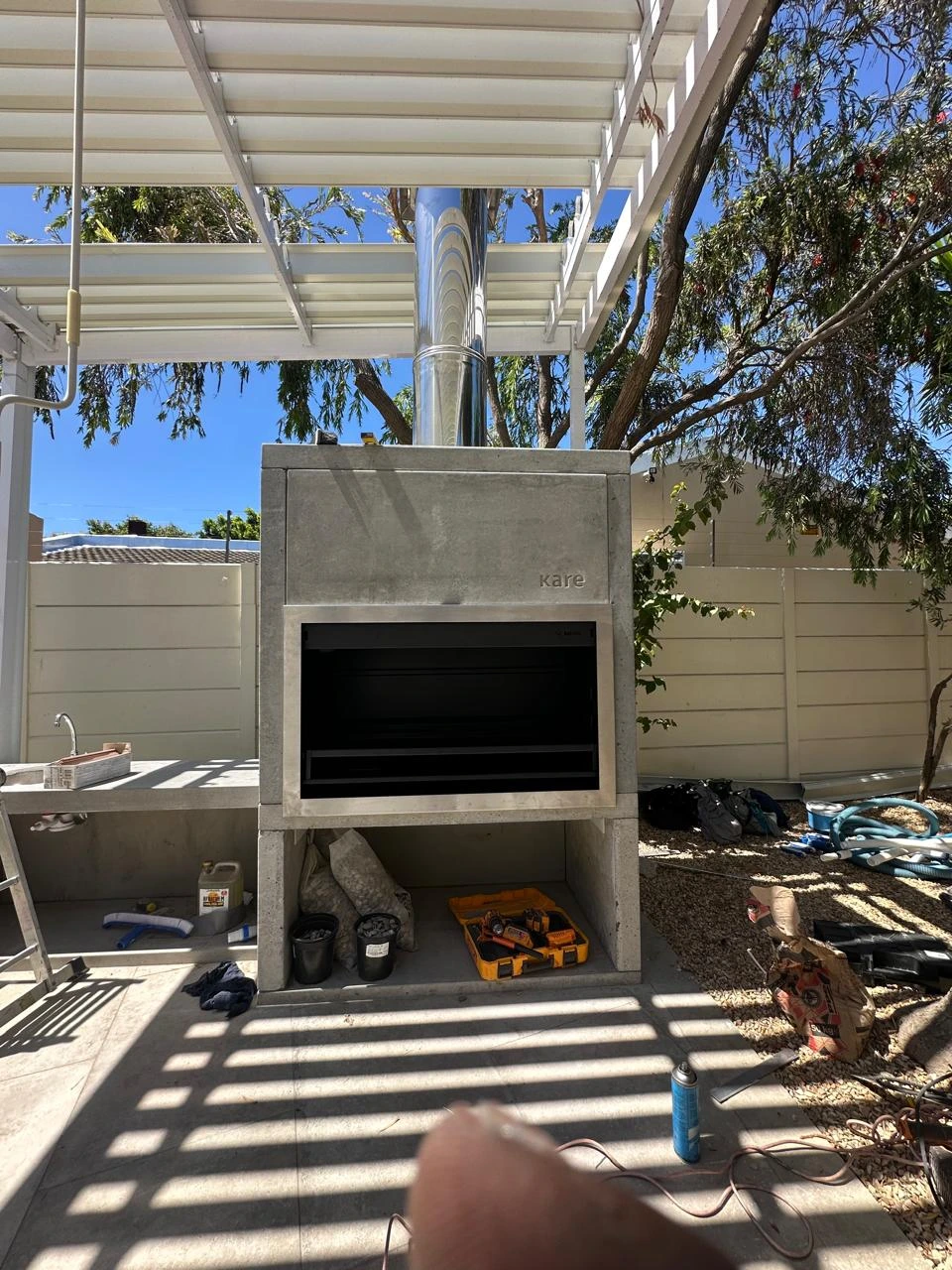 Braai installation with work tools beside the masonry surround