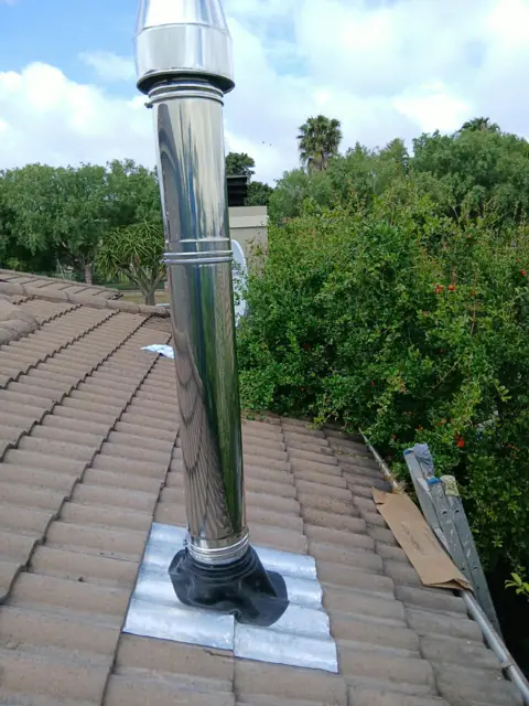 Close-up of the stainless steel flue and roof flashing, Durbanville