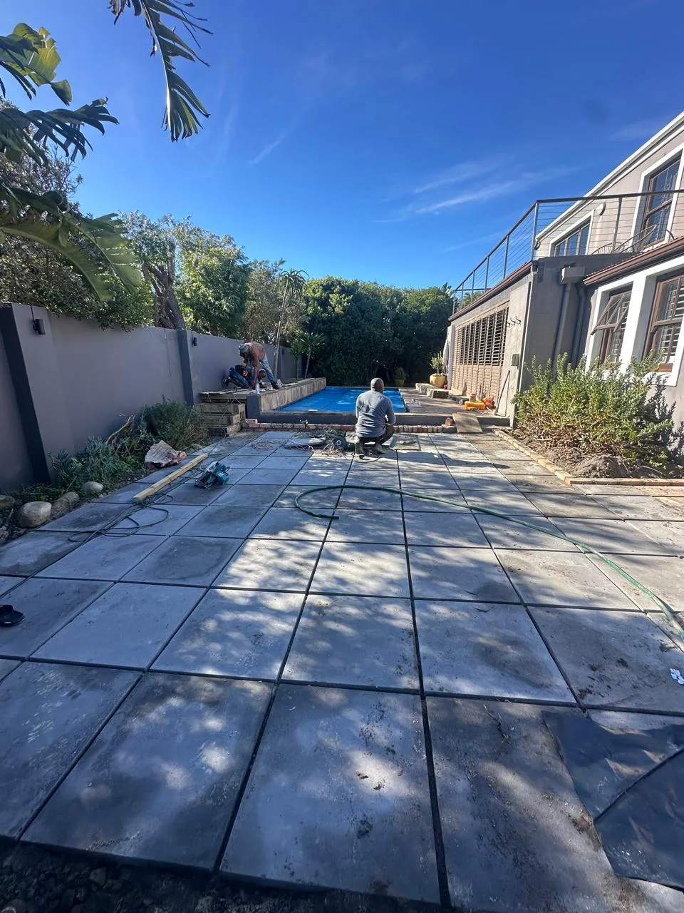 Large paved outdoor entertainment area next to a house