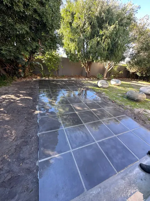 Newly laid paving slabs in the back garden after rain