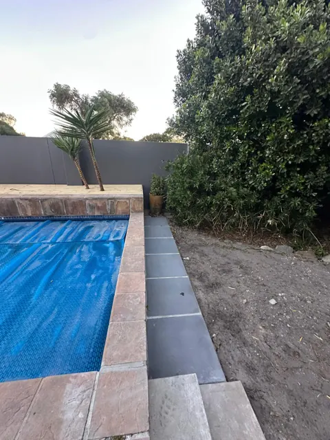 Pool edge with paving strip and new garden bed