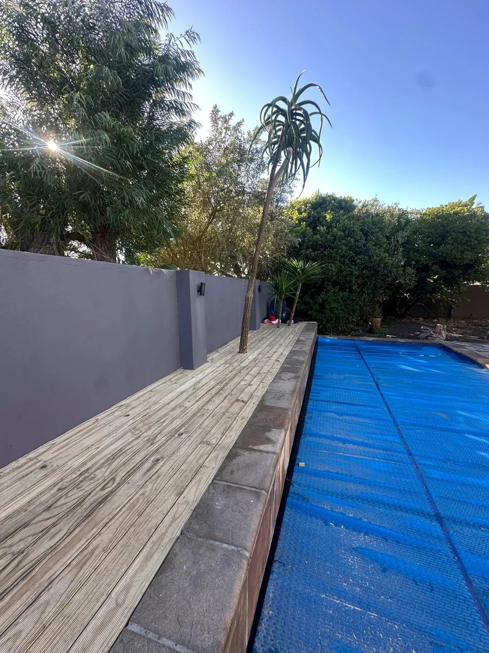 New timber deck built along the pool wall