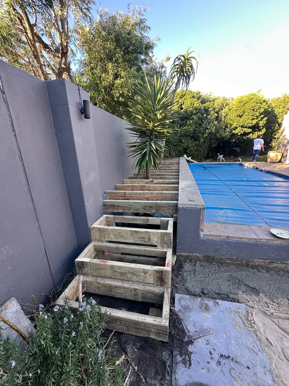 Timber steps built up to the pool deck