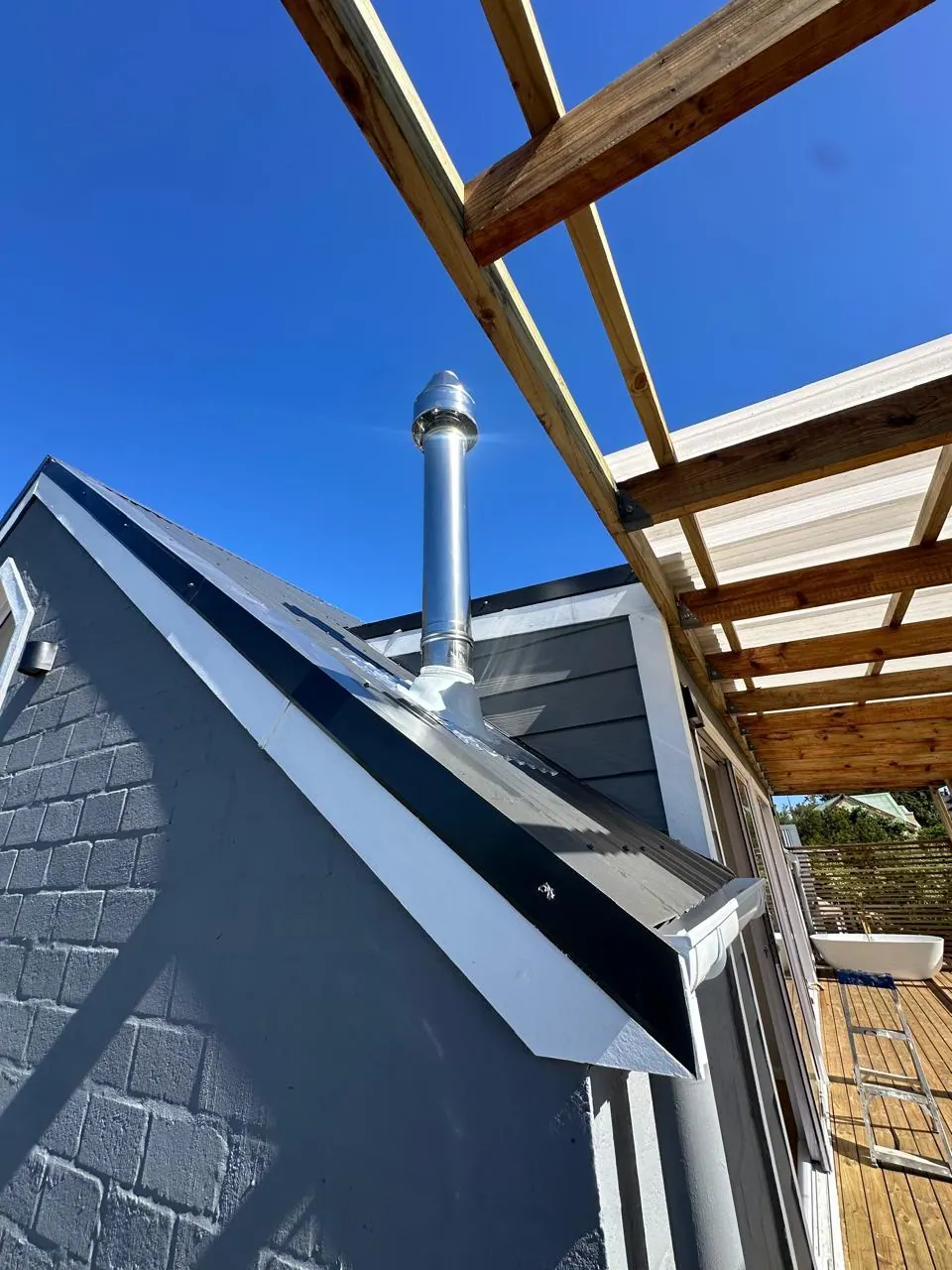 Stainless steel flue exiting the roof sheeting in Kommetjie