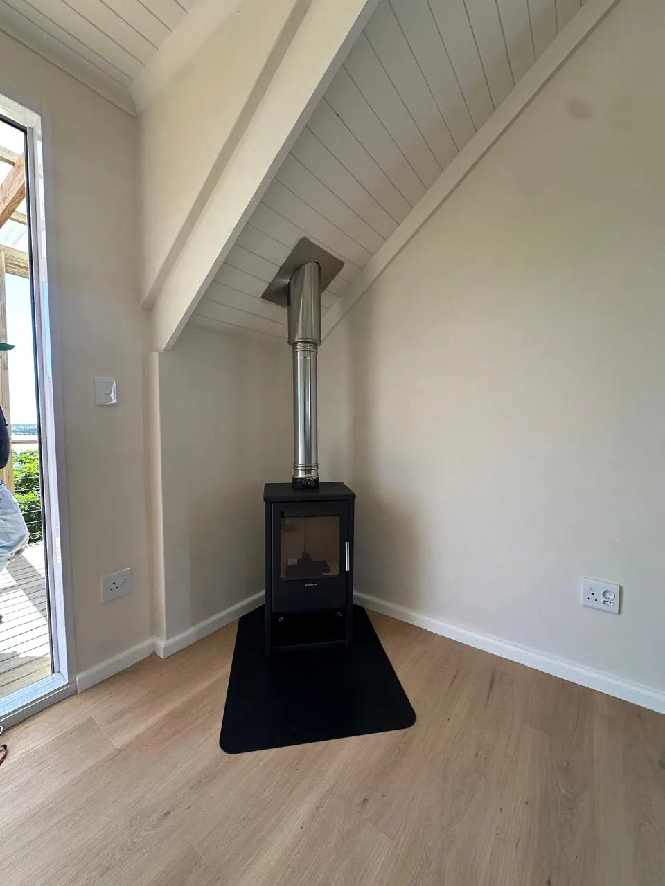 Closed-combustion fireplace in an open-plan living room, Kommetjie