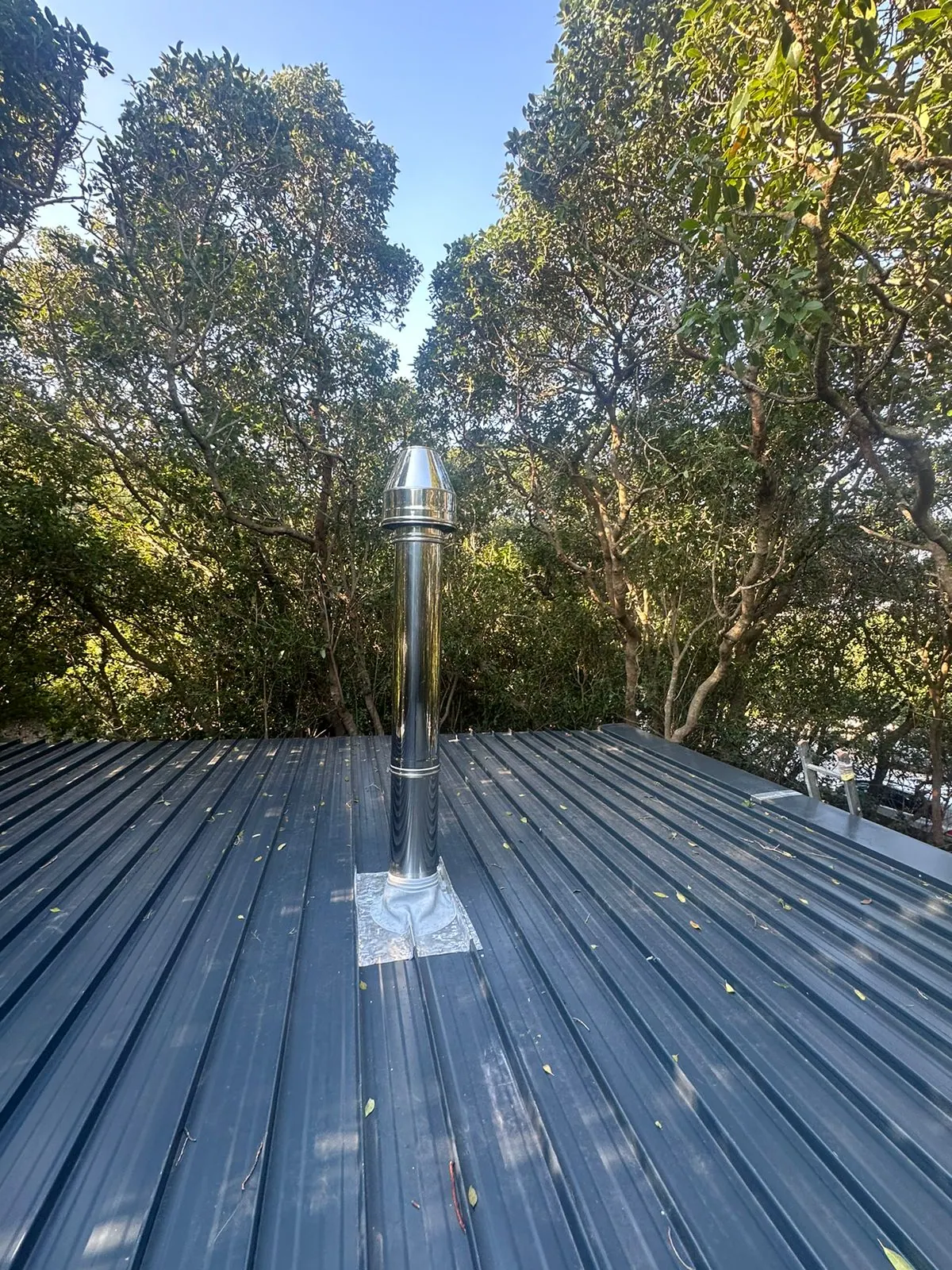 Stainless steel flue penetration through the roof sheeting in Noordhoek