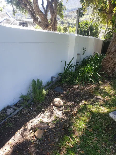 White painted boundary wall and garden in Hout Bay